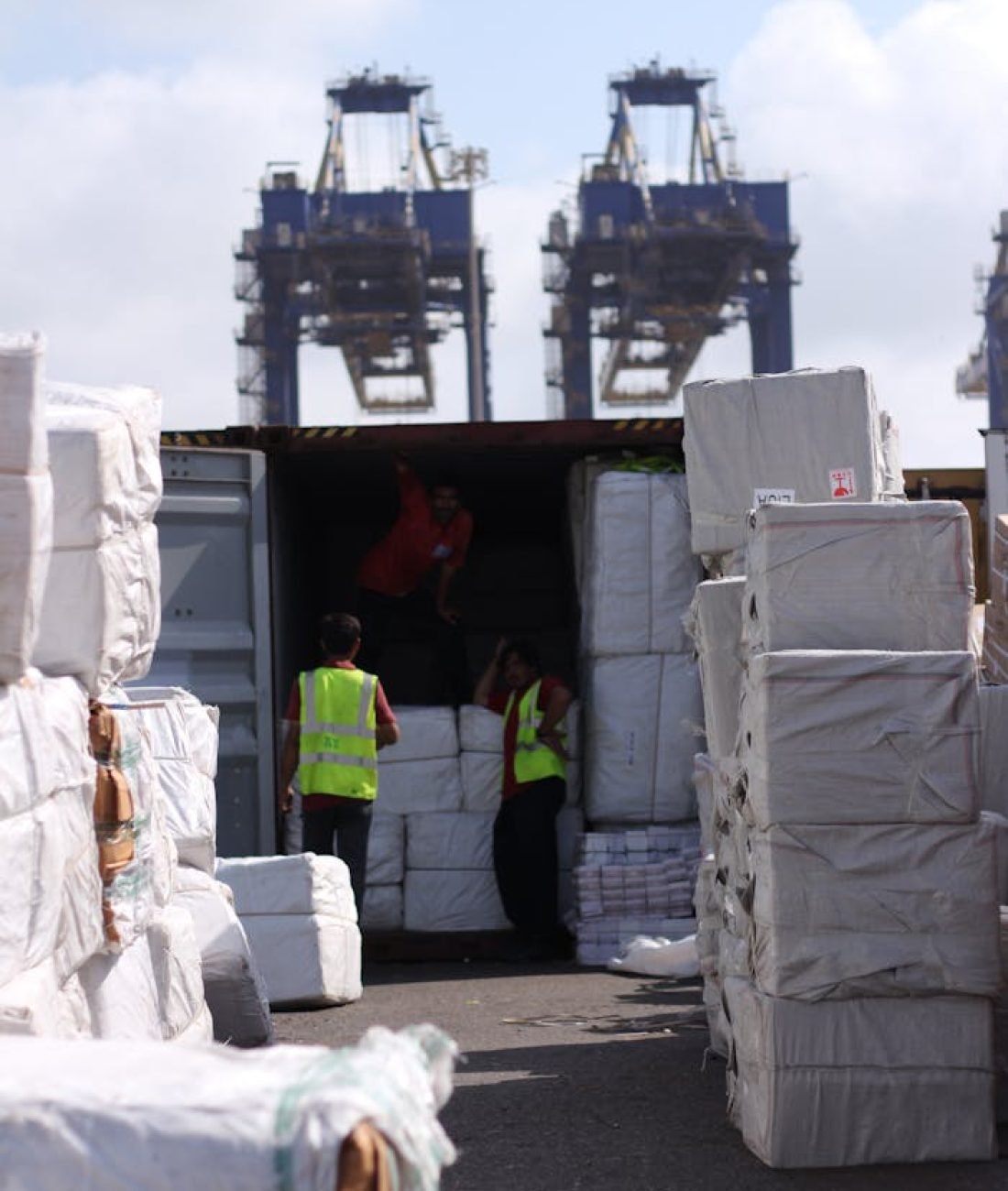 Men Loading Cargo into a Container in a Port